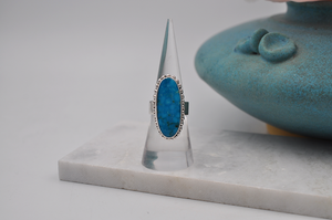Front view of oblong oval Kingman turquoise and sterling silver US Size 7 ring. 