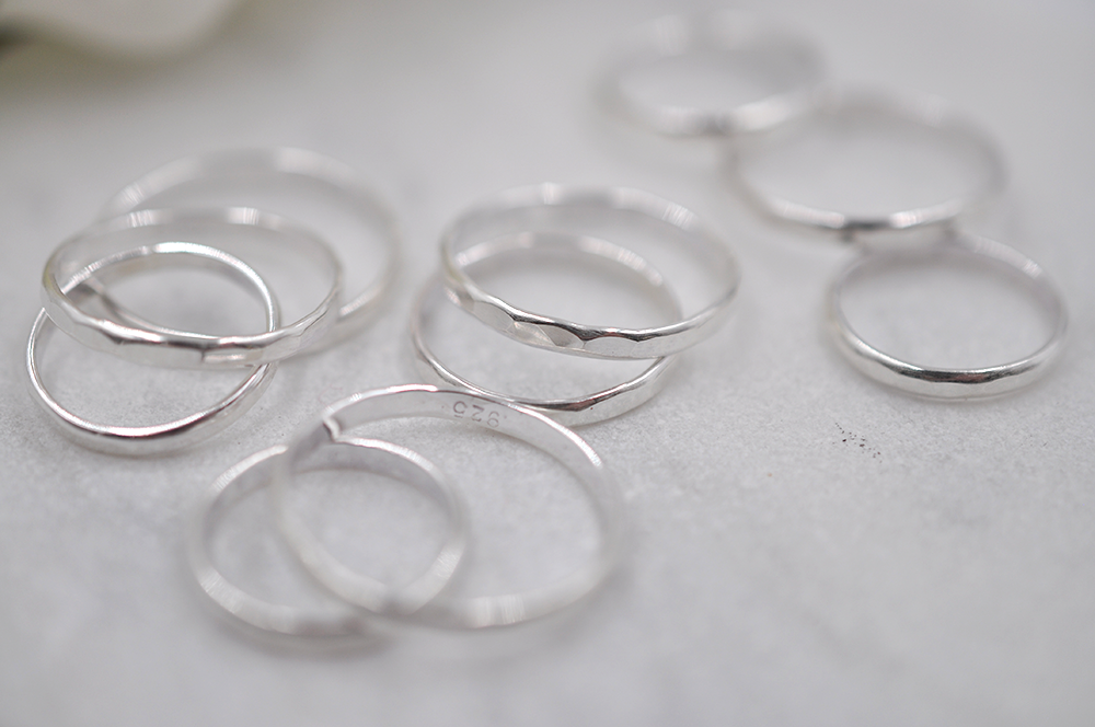 Set of silver rings on a light gray surface