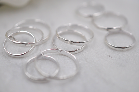 Set of silver rings on a light gray surface