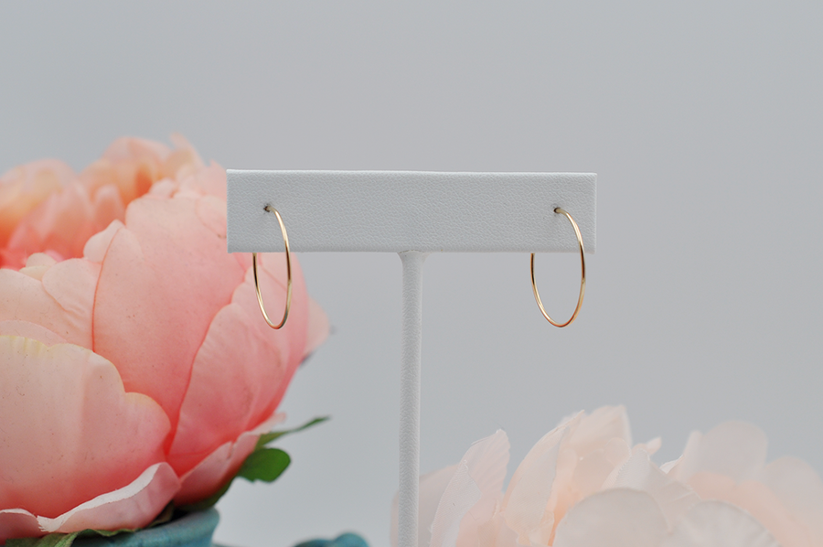 Light weight classic gold hoops are lightweight and perfect for everyday wear. These small wire hoop earrings hang an inch below the ear as pictured in this side view.