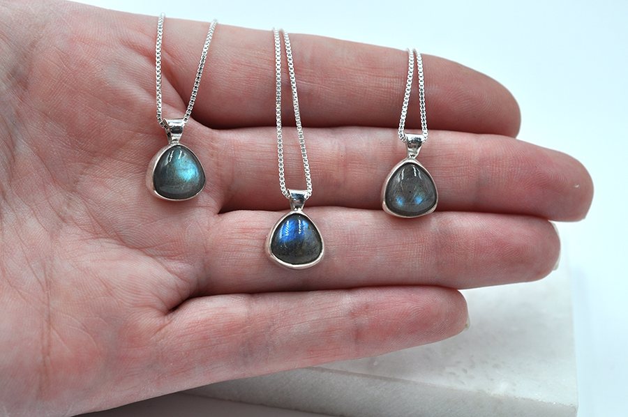 Three small triangle labradorite necklaces, each pictured on a sterling silver box chain. 
