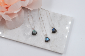 Three small triangle labradorite necklaces, each pictured on a sterling silver box chain. 