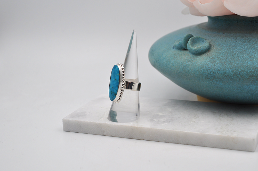 Slight side view of sterling silver Kingman turquoise ring. US Size 7.