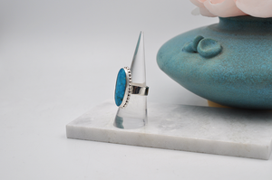 Slight side view of sterling silver Kingman turquoise ring. US Size 7.